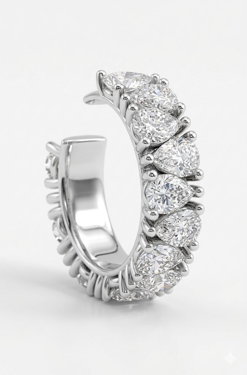 A silver  ear cuff featuring crossing lab grown diamonds shown on a clean white background.

