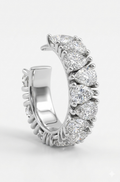 A silver  ear cuff featuring crossing lab grown diamonds shown on a clean white background.

