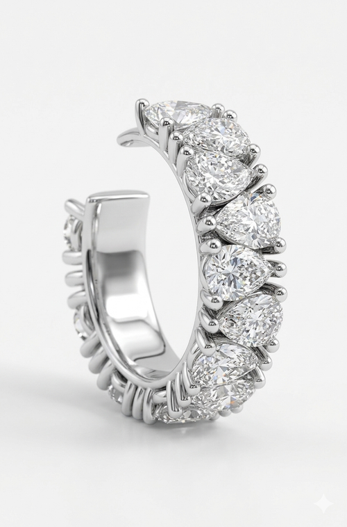 A silver  ear cuff featuring crossing lab grown diamonds shown on a clean white background.

